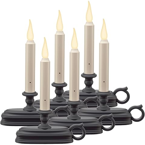 Two LED candles with brass bases on a white background