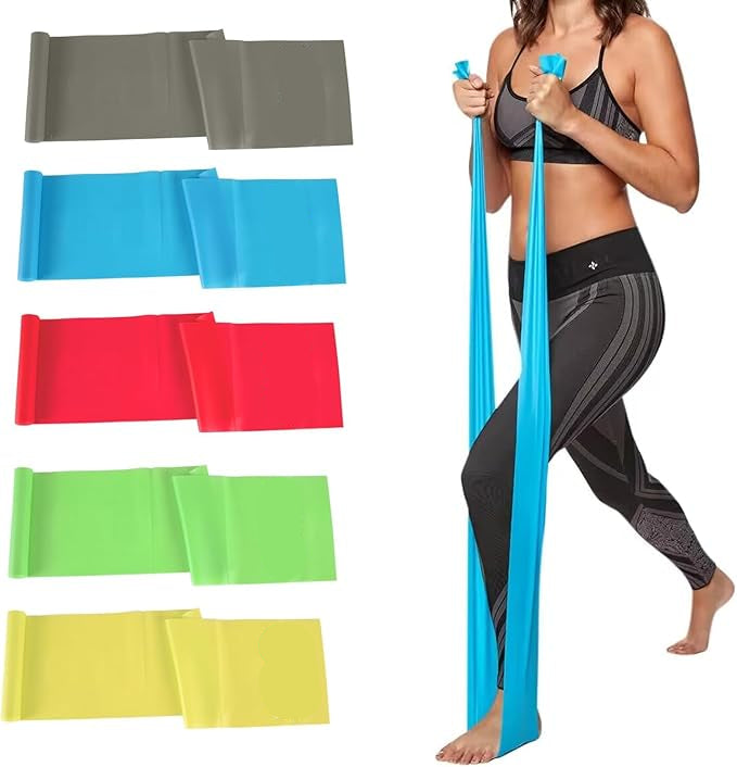 Woman exercising with resistance bands of various colors on a white background