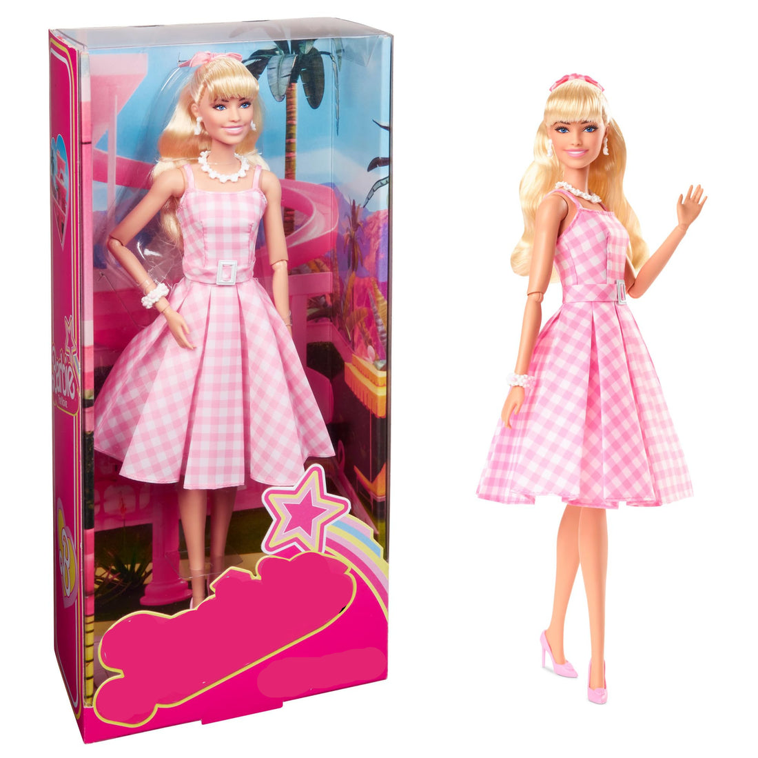 Barbie doll in pink dress with matching box on a white background