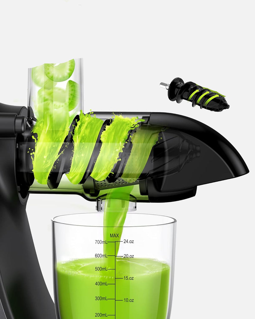 Spiral juicer with green juice being extracted into a glass container.