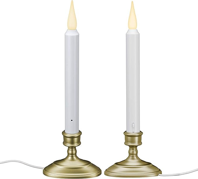 Two LED candles with brass bases on a white background