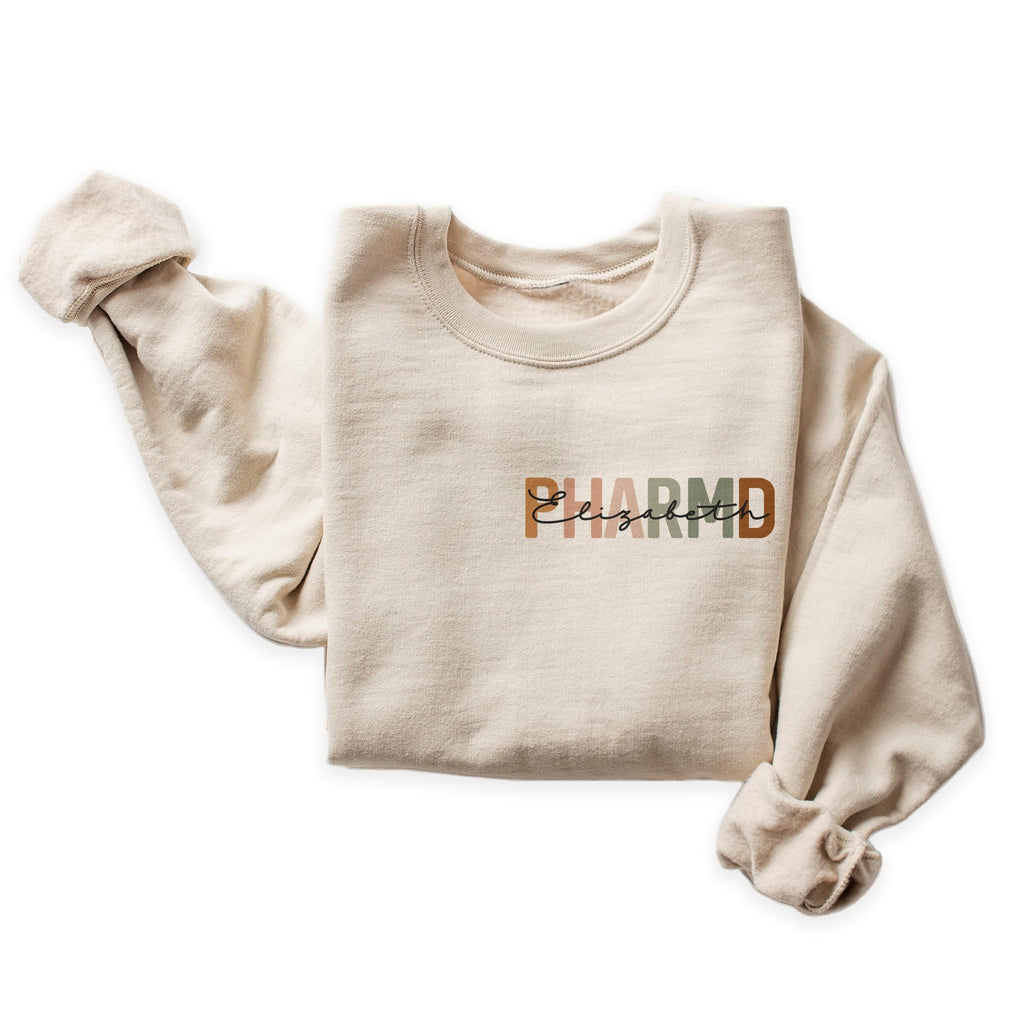 Personalized PharmD Sweatshirt, Custom Left Chest Name Pharmacist Gift, Pharmacology School Graduation, Pharmacy Appreciation Week Shirt, Pharmacist Life Unisex Crewneck Sweatshirt Sand