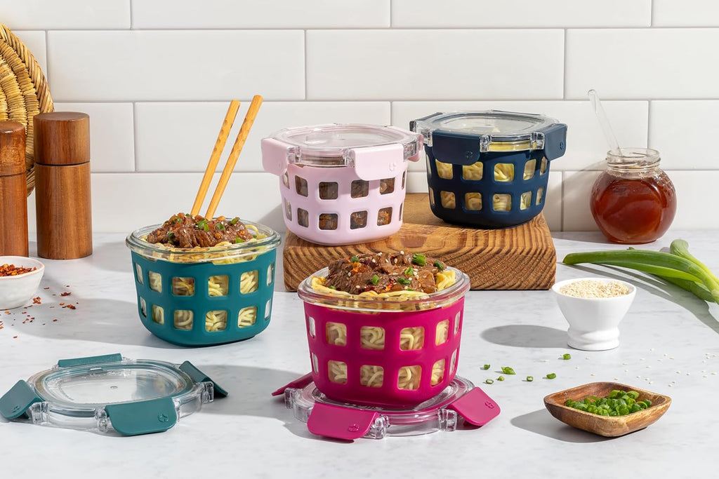 Colorful silicone food containers with lids on a kitchen counter.