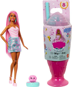 Barbie doll with pink hair and outfit next to a pink packaging container with a small pink figure on a white background