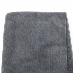 Gray towel with 'pure:est' branding on a white background
