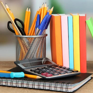 Calculator on a notebook with colorful books and stationery items in the background