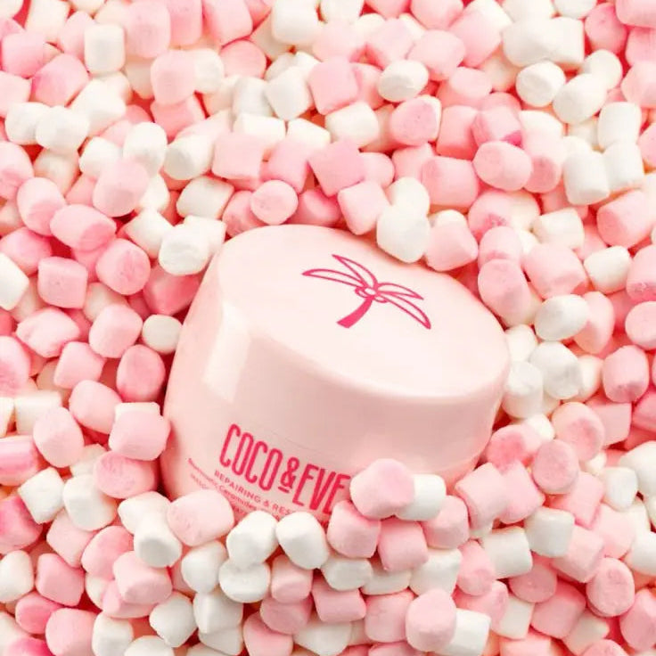 Pink container with 'COCO & EVE' branding surrounded by pink and white candy pieces.