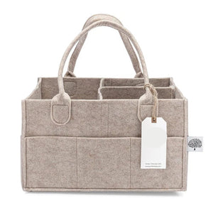 Beige fabric caddy with handles and a visible brand tag on a white background